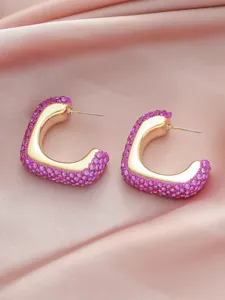 Close-up detail of geometric square rhinestone earrings with pink crystals and gold tone finish.