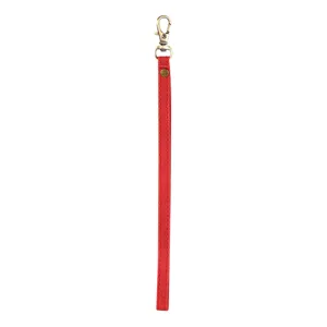 Close-up detail of red leather wrist strap lanyard with vintage bronze metal clasp hardware.