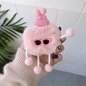 Close-up of cute pink plush AirPods protective case with sunglasses and knitted hat detail.