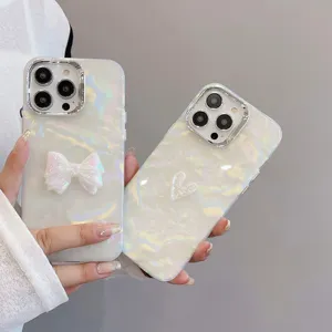 Detail shot of pearlescent shell texture phone case with 3D bow and heart, electroplated.