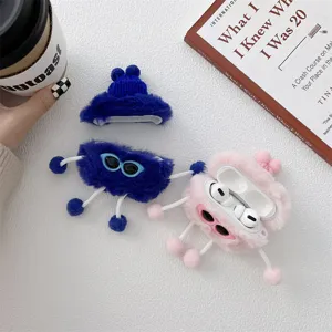 Plush monster AirPods case detail showcasing soft fuzzy texture and cute trendy sunglasses.