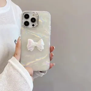 Pearl shell texture phone case detail featuring a shiny 3D bowknot and electroplated frame.