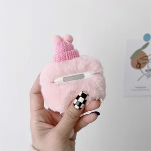 Cute plush AirPods protective case with mini knitted hat design, soft furry cover for Apple wireless earbuds.