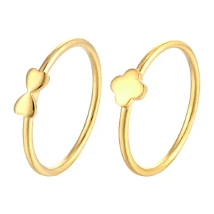 Gold minimalist bowknot and four-leaf clover rings set, delicate finger jewelry piece.