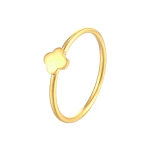 Detailed view of the gold four-leaf clover ring, showing fine polished smooth surface texture.