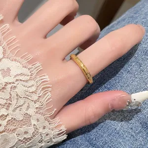 Gros plan détaillé d'une bague élégante en acier titane doré de style chinois avec gravure.