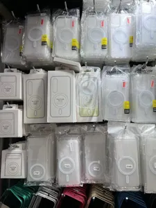 Detailed view of clear magnetic phone cases hanging on display racks, showing transparent acrylic.