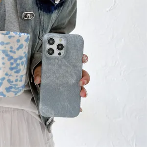 Detalle de la funda para teléfono con textura de mezclilla y recortes precisos y estilo.