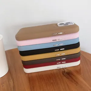 Detailed close-up of colorful liquid silicone phone cases stacked on a wooden table surface.