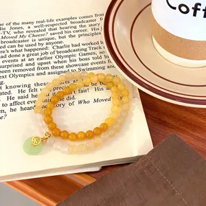 Exquisite natural agate beaded double layer bracelet with green jade peace buckle pendant detail.