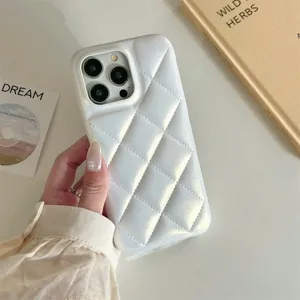 White quilted iPhone case detail showing soft material and diamond pattern texture.