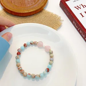 Detailed view of sweet natural stone and pink crystal heart beaded bracelet, elegant and fresh.