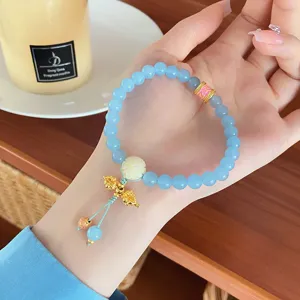 Sweet fresh blue natural stone beaded bracelet with white flower gold pendant for women.