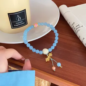Light blue natural stone beaded bracelet with gold accents and cute pendant for women stylish jewelry