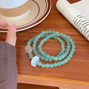Close-up detail of the natural green agate multi-layer bracelet with jade safety buckle.