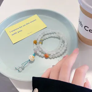 Detailed view of the multi-layer jade beaded bracelet featuring delicate colorful charms.