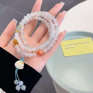Detail view of the multi-layer Tianshan jade bracelet featuring a cute lucky cat pendant.