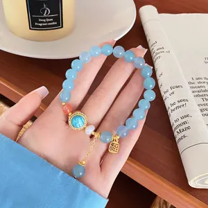 Elegant natural stone blue beaded bracelet with gold charms and pendant for sweet daily wear.