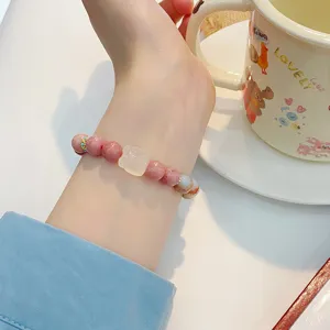 Sweet pink crystal stone bead bracelet with carved white charm for women daily wear.