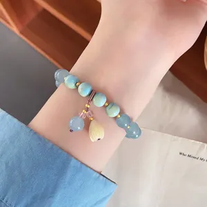 Close-up detail shot of the refreshing blue natural stone bracelet featuring cute lily drop.