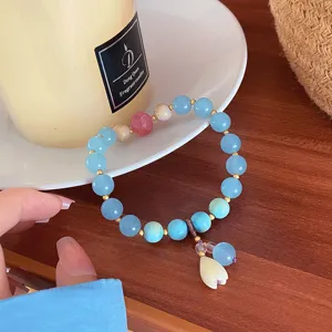 Blue natural stone bracelet with lily of the valley and cat paw detail, delicate jewelry piece.
