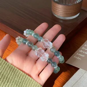 Detail view of sweet mint green fluorite crystal bracelet with cute bear and heart charms.