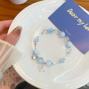 Blue cracked crystal glass bead bracelet with cute shell and tail charms for women and girls.