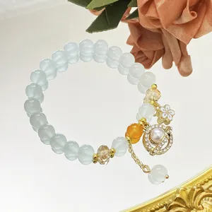 Délicat bracelet en perles de cristal avec pendentif planète et fleur pour les filles.