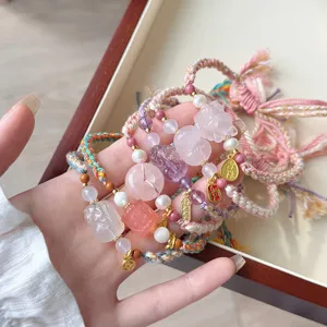 Detailed view of Tibetan ethnic woven adjustable bracelet with natural rose quartz and amethyst.