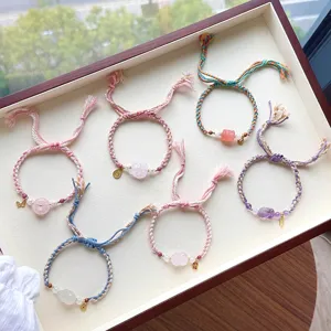 Handmade woven braided rope bracelet set featuring natural pink crystal and amethyst charms.