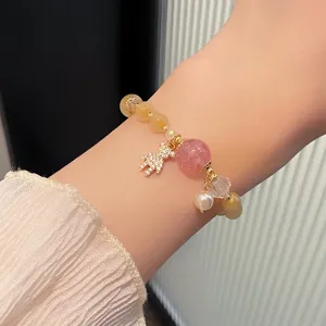 Sweet crystal beaded bracelet with strawberry quartz, rutilated quartz and a cute bear charm.