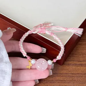 Handmade pink crystal donut bracelet detail, featuring sweet woven cord and cute butterfly charm.