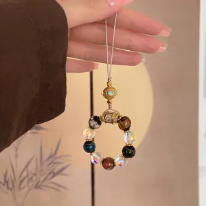 Detail shot of exquisite palace style multi-color crystal bead phone charm bag pendant.