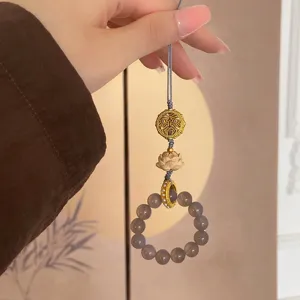Detailed view of grey agate bead lotus phone charm. Elegant palace style bag accessory.
