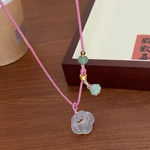 Chinese style natural white agate ruyi necklace with pink braided cord and green beads detail.