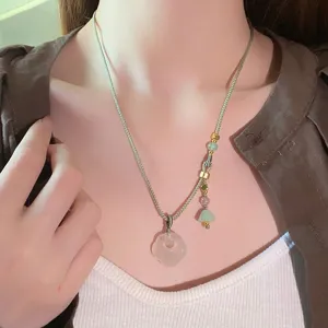 Elegant white agate ruyi pendant necklace detailed view, new chinese style jewelry close up.