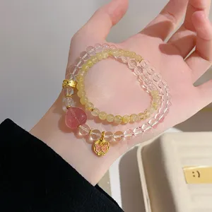Natural crystal double layer bracelet with strawberry quartz heart and gold butterfly pendant for women.