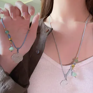 Close-up detail of the Chinese style white agate ruyi pendant necklace, elegant accessory.
