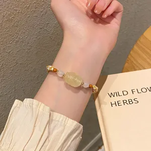 Close-up detail of the elegant carved pixiu charm bracelet featuring delicate bead accents.
