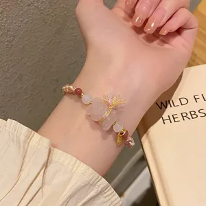 Detailed shot of the crystal carved bracelet on wrist, showcasing delicate braided threads.