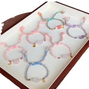 Tibetan ethnic braided adjustable bracelet with natural rose quartz and amethyst charms.