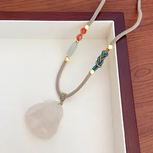 Natural white agate Buddha pendant long sweater chain with braided rope and vintage beads detail.