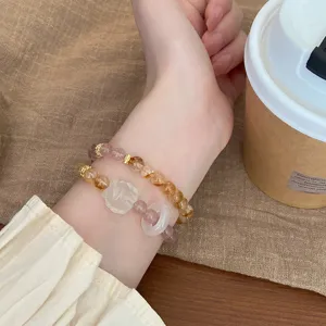 Gros plan sur le bracelet de perles en pierre precieuse de cristal avec pendentif naturel.