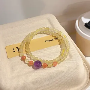 Close-up of double layer crystal beaded bracelet with amethyst and yellow quartz details