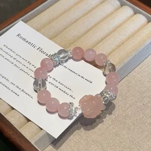 Elegant natural rose quartz crystal beaded bracelet featuring sparkling rhinestone spacers.
