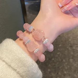 Close-up detail of the sweet pink crystal bracelet with carved fox charm and silver crown beads.