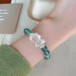 Close up of crystal bear mint green fluorite bracelet, delicate silver spacers detail view.