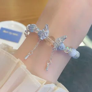 Close-up detail of new Chinese style vintage blue cracked crystal beaded bracelet with butterfly.