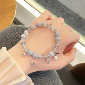 Exquisite blue crystal and cat-eye bead bracelet detail showcasing retro Chinese style charms.