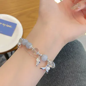 Elegant crystal bead bracelet featuring a charming mermaid tail and seashell pendant design.